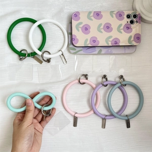 Silicone phone wrist strap showing flexibility with metal spring buckles and clear patches