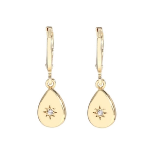 Elegant gold teardrop earrings with central zircon and star pattern on white background
