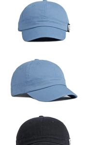 Detail view of cotton short brim baseball caps with side decorative logo patches