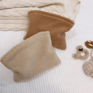 Detailed texture of soft sherpa fleece cosmetic bags in beige and caramel brown tones