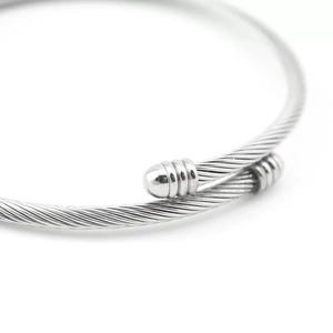 Detailed macro view of the silver twisted wire cable bangle with smooth metal end caps