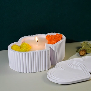 Macro detail of striped heart-shaped storage box mold with decorative wax flowers