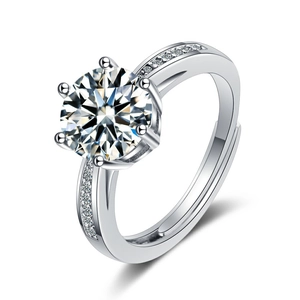 Silver open ring featuring a large round cubic zirconia and diamond-set wide band