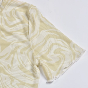 Macro detail of breathable mesh fabric with abstract marble print and stitching on shoulder
