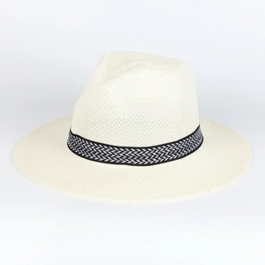 Detailed view of woven straw sun hat with black and white geometric patterned ribbon