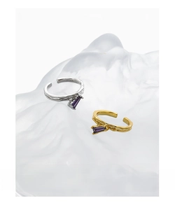 Close-up of S925 sterling silver open rings with irregular texture and purple zircon