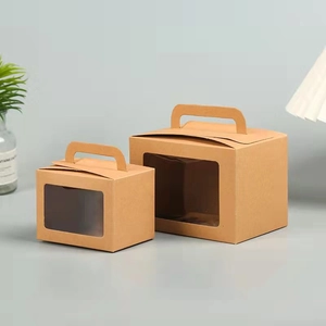 Detail of two kraft gift boxes with clear windows and handles in natural brown color