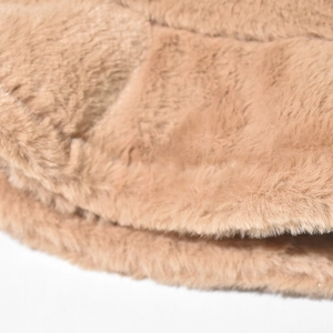 Detailed macro view of soft light brown plush faux fur texture and warm thick fibers