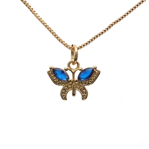 Golden box chain necklace with a delicate blue zircon butterfly pendant on white background