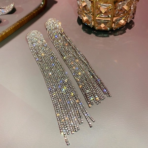 Detailed view of silver tassel earrings featuring high-shine crystal rhinestones