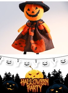 Detail of Halloween pumpkin doll with orange plush head and black wizard hat decor