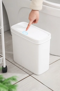 Close-up of slim white trash can with press-top lid showing the one-touch opening mechanism