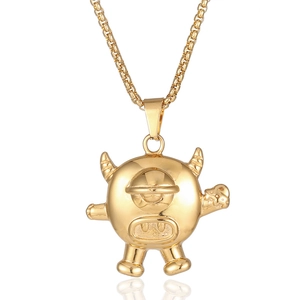 Polished gold hip-hop monster pendant with box chain on white background with reflection