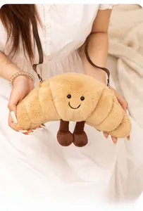 Gros plan du sac bandoulière croissant en peluche avec visage souriant et sangle réglable