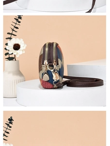 Close-up of retro color-block crossbody bag with double zippers and golden hardware