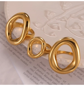 Macro shot of minimalist gold irregular hollow rings on an artistic vintage paper
