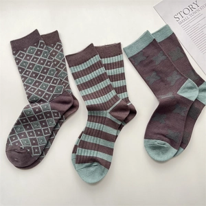 Three pairs of vintage plaid and striped cotton socks in brown and mint green colorway
