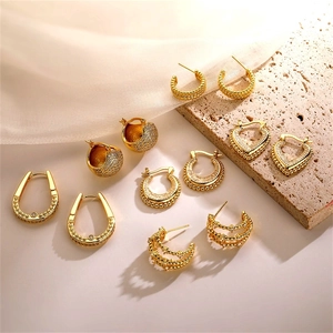 Detailed collection of vintage 18K gold-plated earrings with zircon heart and textured hoops