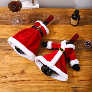 Christmas wine bottle covers featuring red velvet Santa suit and dress on a wooden table