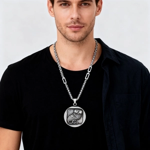 Polished silver owl coin pendant in vintage style with stainless steel chain on male model