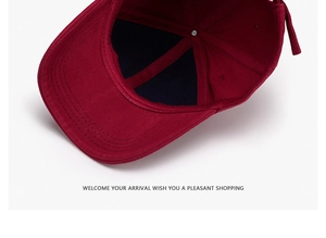 Detail view of burgundy cotton baseball cap interior showing stitching and reinforced seams