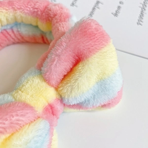 Close-up of the soft rainbow striped flannel texture and bowknot on the headband