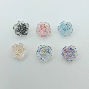 Detailed view of colorful resin camellia flower charms for 3D nail art and DIY jewelry