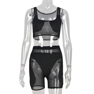 Women's black two-piece mesh patchwork set featuring a crop top and high-waisted shorts