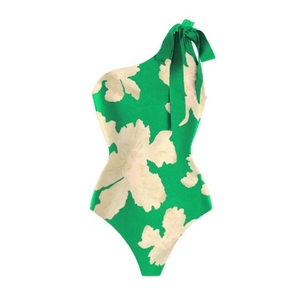 Detail of one-shoulder floral swimsuit with green base and elegant ruffle bow tie