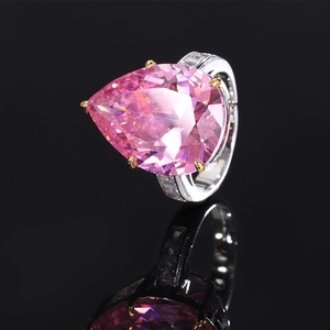 Elegant silver ring with pear-cut pink zircon stone and diamond-studded band on black mirror