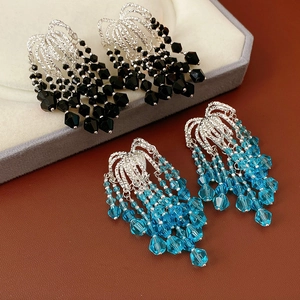Detail of luxury fringe earrings with black and blue crystal glass bead tassels