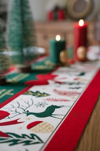 Macro view of Christmas table runner with jacquard reindeer and snowflake patterns