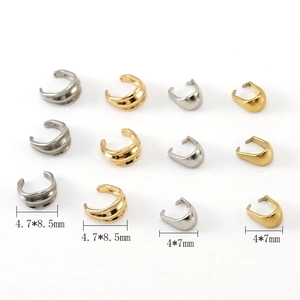 Detailed view of 18K gold and silver steel earring clips in two sizes and wave patterns