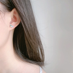 Exquisite butterfly stud earrings with colorful zircon stones worn by a model