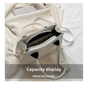 Top view of the white quilted handbag interior showing large capacity for daily items