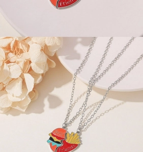 Detail of hamburger and fries BFF necklaces with Best Friends engraving on enamel charms