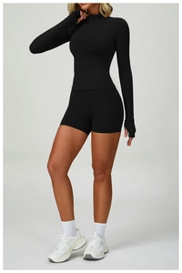 Detailed view of women's black yoga set with zip jacket, thumb holes and slim fit shorts