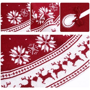 Red and white knitted Christmas tree skirt featuring snowflake and reindeer patterns
