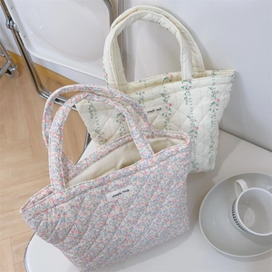 Detailed macro view of quilted floral cotton tote bags featuring simple wish textile labels