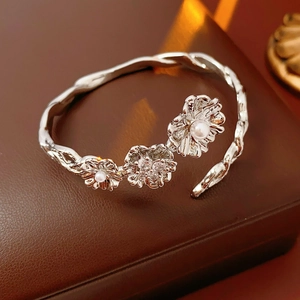 Macro shot of silver flower bracelet with pearls and zircons on leather display box