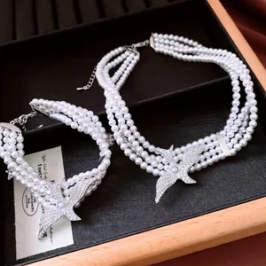 Multi-layer pearl necklace and bracelet set with silver swallow pendants and rhinestones