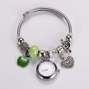 Detail view of silver Pandora style bracelet with apple pendant and mini quartz watch