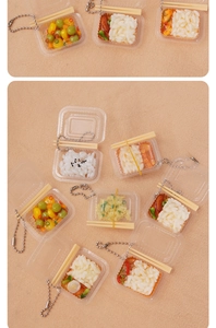 Macro detail of miniature food keychain with assorted rice dishes and tiny chopsticks