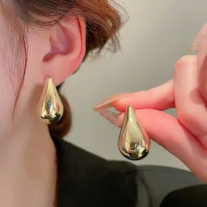 Minimalist gold teardrop earrings with a high-polished liquid metal finish for women