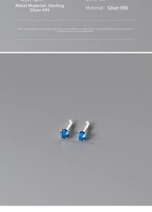 Detail of 999 silver four-claw stud earrings featuring round blue sapphire-style stones