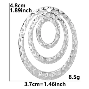 Detail of silver oval necklace charm with hammer finish and 4.8cm height dimensions