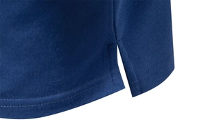 Detail of navy blue pique knit polo shirt showing side slit and fine seam stitching