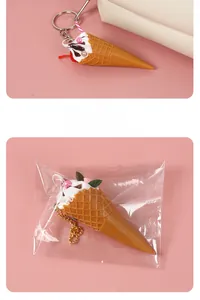 Detailed close-up of realistic mini ice cream cone keychain with cherry and chocolate sauce