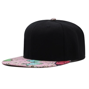 Side view of black snapback hat featuring pink butterfly print on a flat brim style
