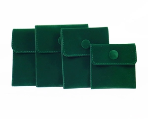 Detailed view of dark green velvet jewelry pouches in four sizes with button closure